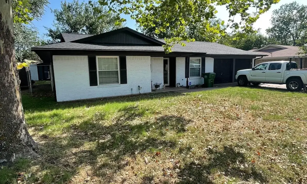 Professional roofing crew working on a residential roof in Selma